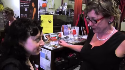 Sexy Lesbian Milf Seduces A Younger Busty Girl In A Shop